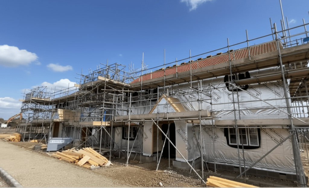 Wrapped exterior of a low-carbon timber frame Newquay house under construction for St Petrocs supported housing.